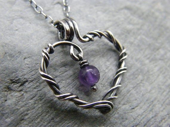 Sterling silver amethyst heart necklace Handmade sterling silver birthstone necklace with amethyst This tiny birthstone necklace is made to order from sterling silver and will measure approximately 17mm in length. The amethyst stone is approximately 4mm and looks perfect inside the heart pendant. Heart Cut Amethyst Birthstone Jewelry, Purple Heart-cut Sterling Silver Necklace, Purple Heart Cut Sterling Silver Necklace, Purple Heart Pendant Jewelry Gift, Purple Heart-shaped Birthstone Necklace, Purple Heart Birthstone Necklace, Anniversary Amethyst Heart Necklace, Personalized Purple Heart Jewelry, Heart-shaped Amethyst Necklaces As Gifts