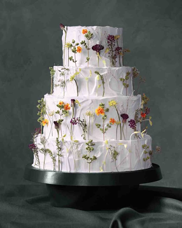 a white wedding cake with flowers on it