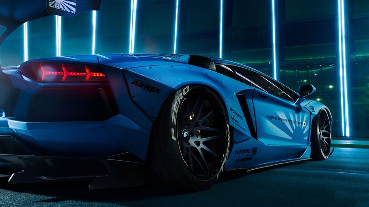 a blue sports car parked in front of a building with neon lights on the side