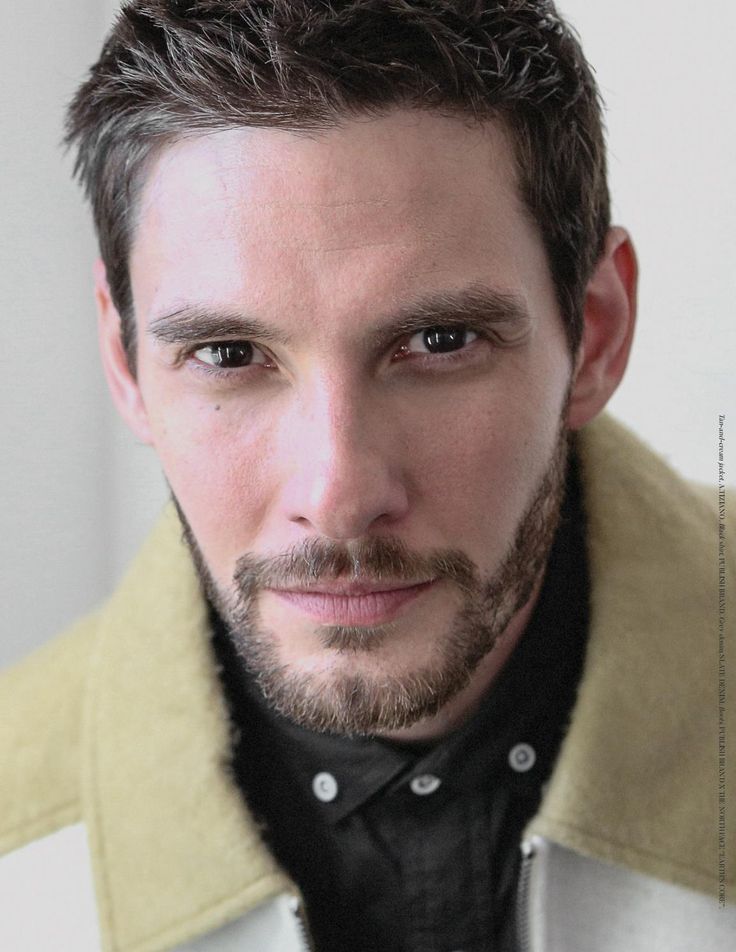 a close up of a person wearing a jacket and tie