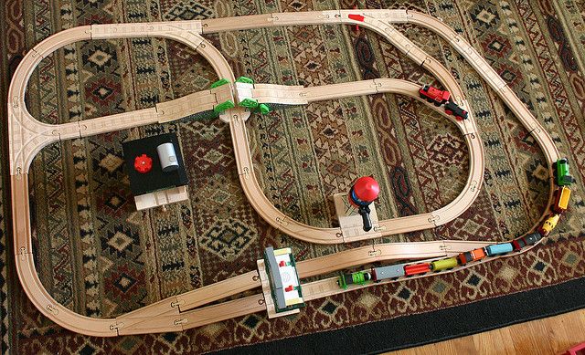 a toy train set sitting on top of a rug