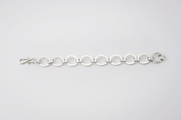 One of a kind! Each link of this statement bracelet was hand-forged in sterling silver. Features a custom decorative sterling clasp. This is a beautiful bracelet! A great gift idea! Measures ½ in width and 7 ½ inches in length including clasp. Materials: Sterling silver Ready to ship. Formal Modern Sterling Silver Bracelet, Modern Polished Sterling Silver Bracelet, Modern White Sterling Silver Bracelet, Modern Link Bracelets With Polished Finish, Sterling Silver Jubilee Link Bracelet, Modern Silver Chain Bracelets, Modern Sterling Silver Jubilee Bracelet, Modern Sterling Silver Oval Link Bracelet, Modern Sterling Silver Bracelet