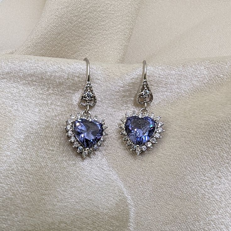 This gorgeous Sterling Silver cubic zirconia studded Tanzanite heart necklace and earring set would make the perfect classy gift for a bridesmaid, as an anniversary gift, for Valentine's Day or for Mother's Day. Tanzanite is the birthstone for those born in December, making it a thoughtful birthday gift as well! Pictures were taken both indoor and outdoors to best represent color. ~Measurements~ The heart pendant measures 1" tall and 3/4" wide. The Tanzanite heart stone is 12mm x 12mm. The match Born In December, Well Pictures, Tanzanite Jewelry, Jewelry Heart, Heart Stone, Jewelry Bridal, Necklace And Earring Set, December Birthstone, Hair Accessories Jewelry