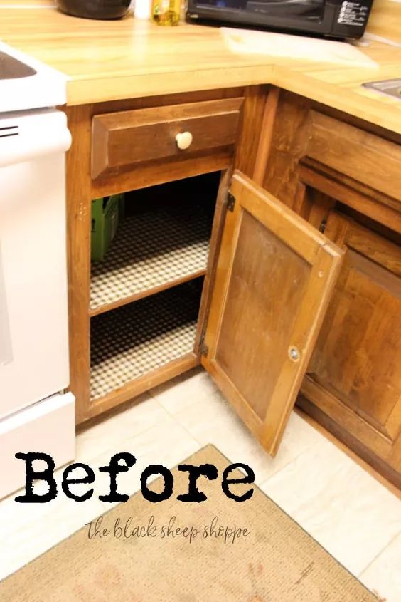 an open cabinet in the corner of a kitchen