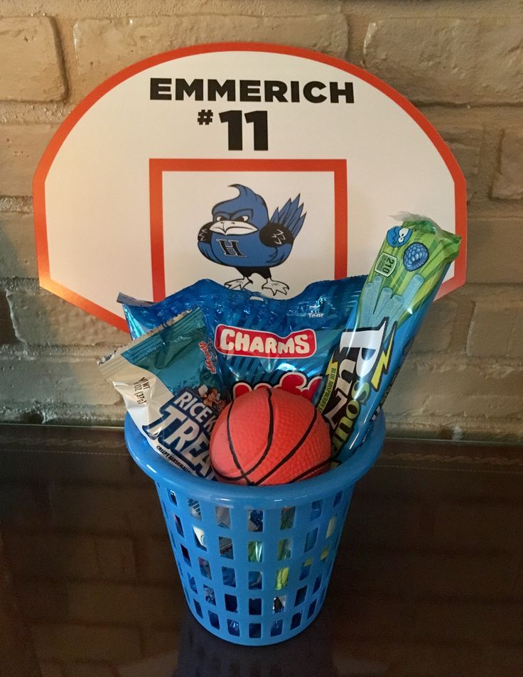 a basket filled with candy and sports items next to a sign that reads emmerich 11