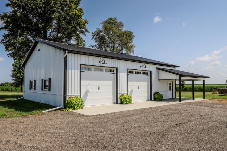 a large white building with two garages on the side