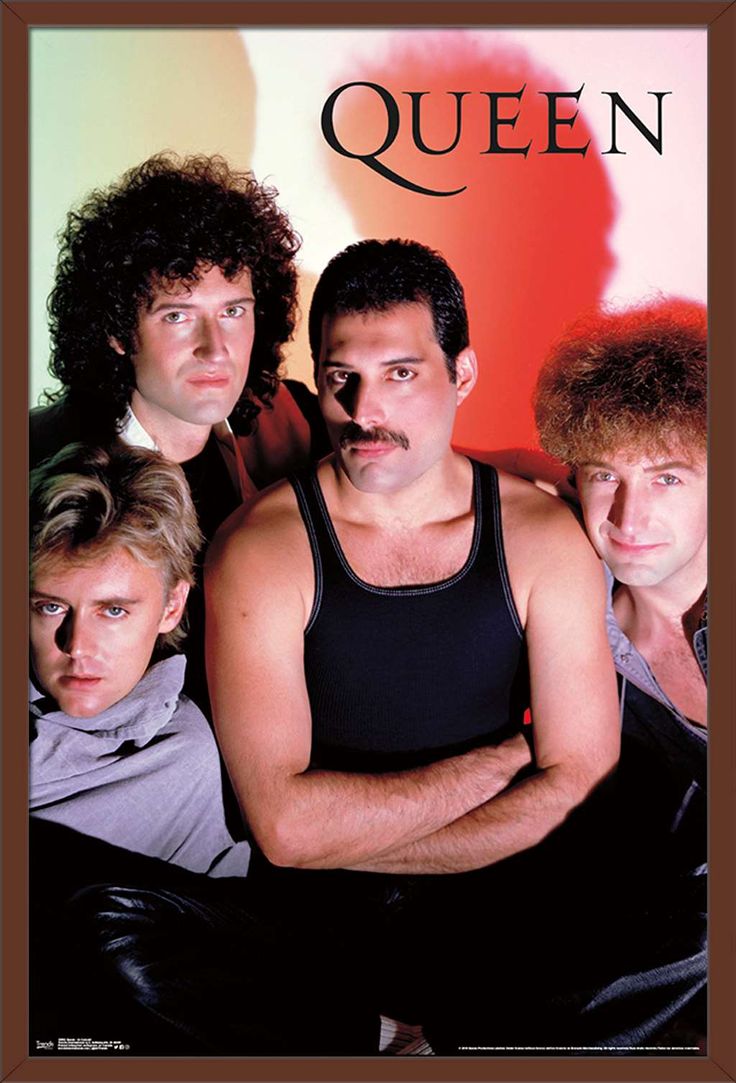 four men are posing for the camera in front of a colorful background, one is wearing a tank top and the other has a moustache on his face