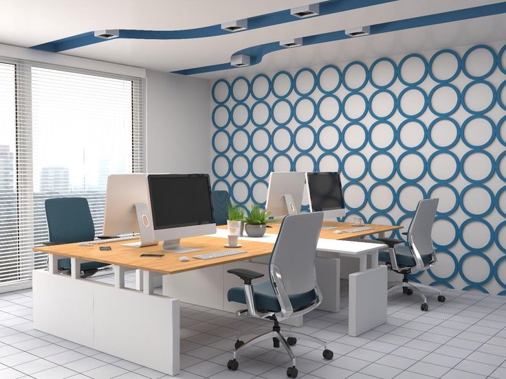 an office with blue and white wallpaper on the walls, desks and chairs