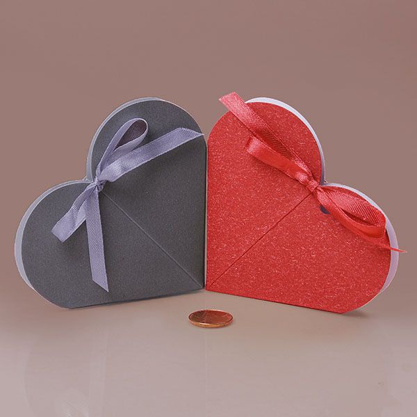 two heart shaped gift boxes sitting next to each other