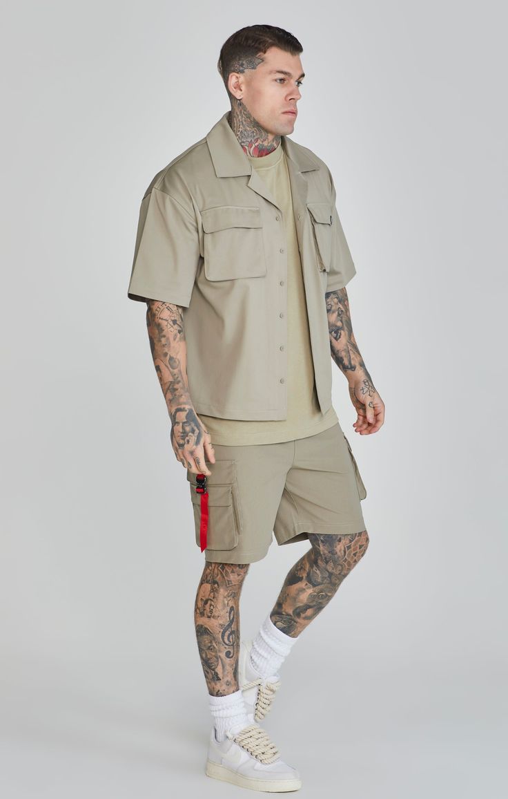 Khaki Flight Utility Shirt Branded tape logo Relaxed fit Custom buttons Utility chest pocket with buckle closure Machine Wash 100% Polyester Utility Shirt, Dress Joggers, Custom Buttons, Mens Khakis, Clothing Essentials, Jogger Jeans, Trouser Jeans, Dresses With Leggings, Jeans Shorts