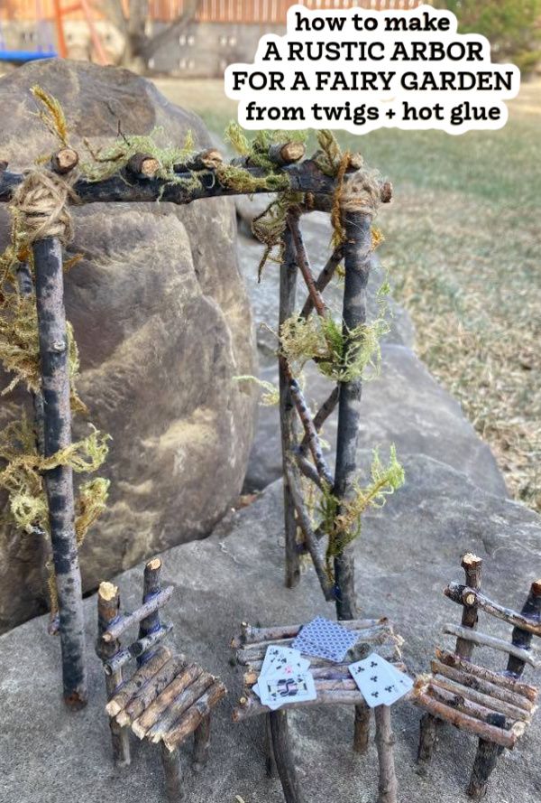 an outdoor table and chairs made out of branches with text overlay that reads, how to make a rustic arbor for a fairy garden from twigs - hot glue