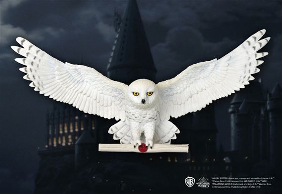 a white owl statue sitting on top of a table