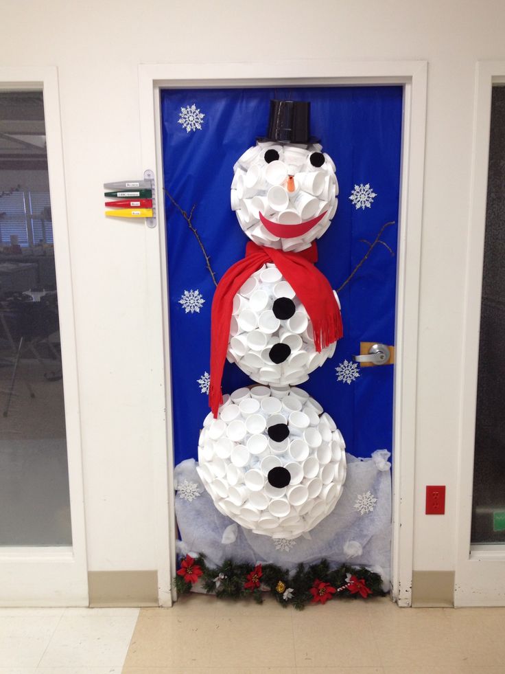 a snowman made out of toilet paper on the front door