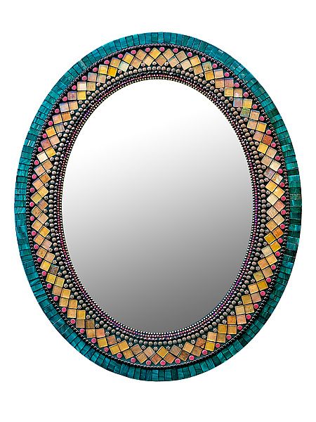 a round mirror with an intricate design on it