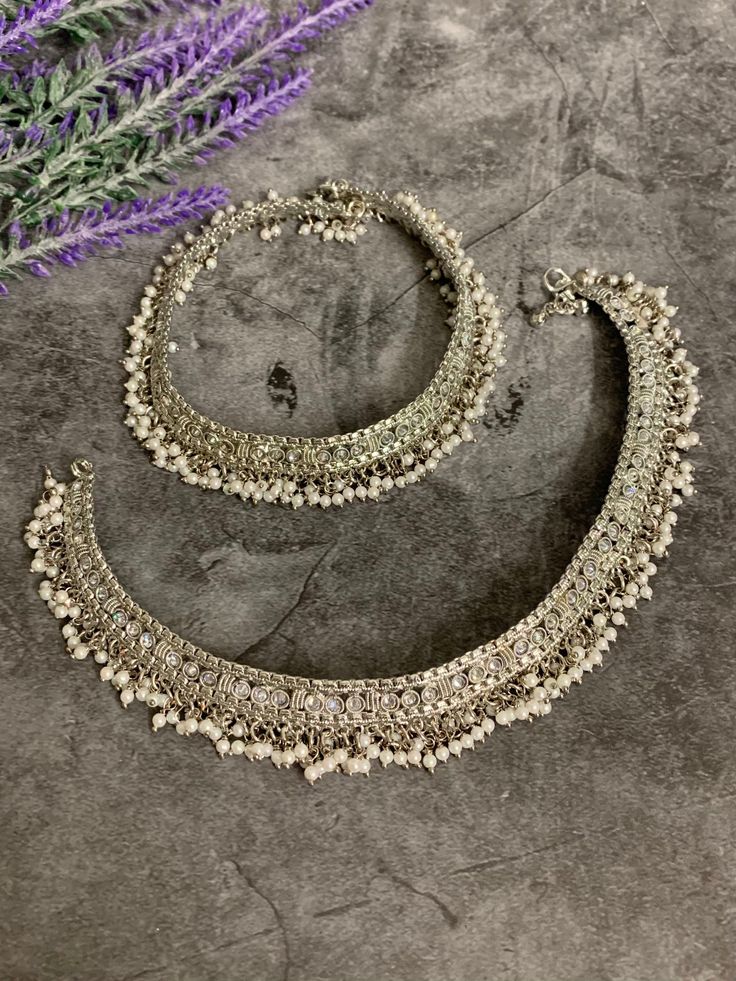 Bridal Antique payal set (pair). Brass made very flexible . Clear reverse polki and bell . About 9 inch long each and 4.5 inch closed. Traditional Silver Beaded Wedding Anklets, Traditional Wedding Anklets In Silver, Traditional Silver Anklets For Wedding, Traditional White Anklets With Silver Beads, Festive Silver Oxidized Anklets, Festive Silver Anklets With Oxidized Finish, Festive Silver Beaded Anklets For Festivals, Festive Silver Beads Toe Ring Anklets, Festive Toe Ring Anklets With Silver Beads