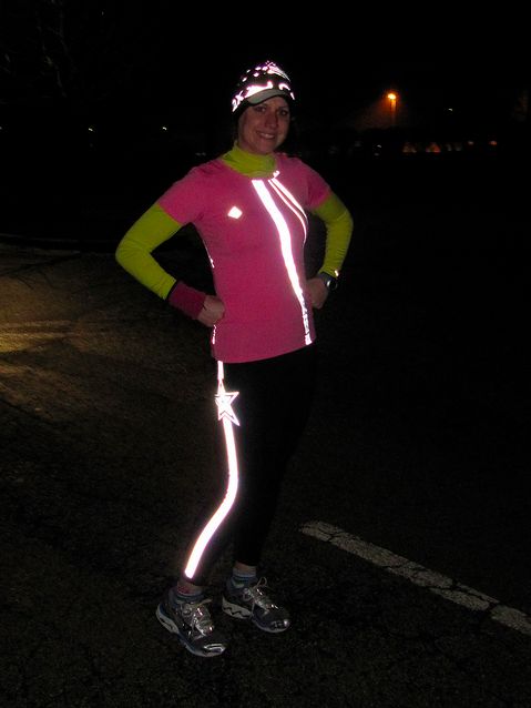 a woman is standing in the street at night with her arms on her hips and glowing shoes