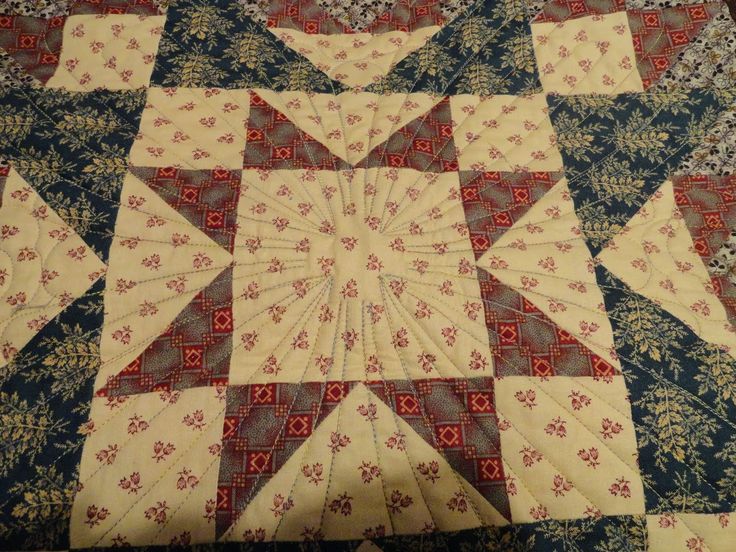 a quilted table topper with red, white and blue designs on it's edges