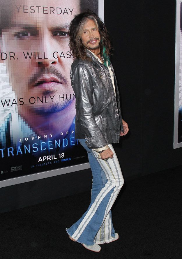 a man standing in front of a movie poster