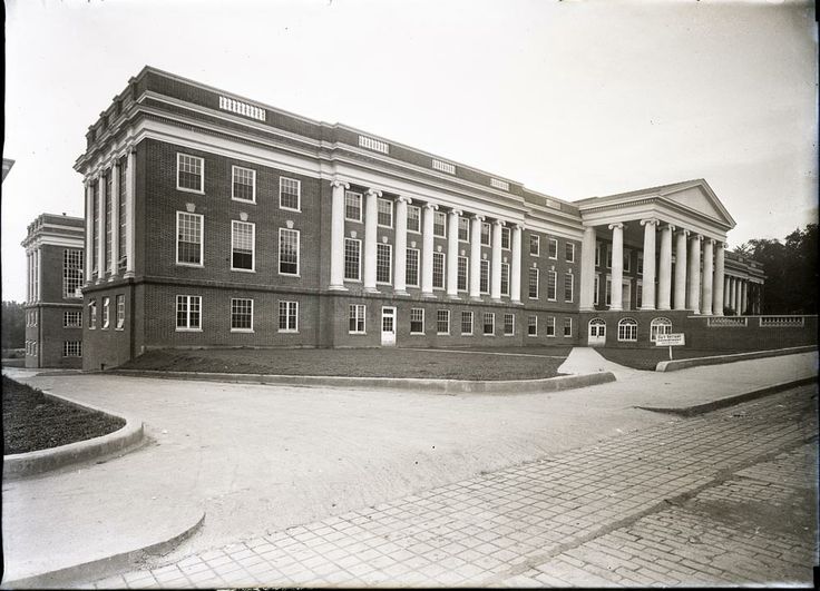 an old black and white photo of a large building with columns on the top floor