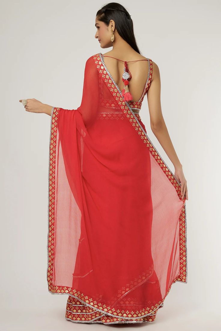 a woman in a red sari with an open back