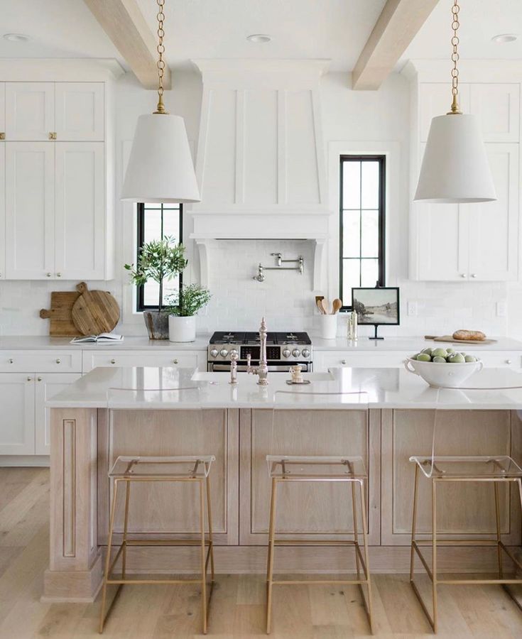 a kitchen with two stools and an island