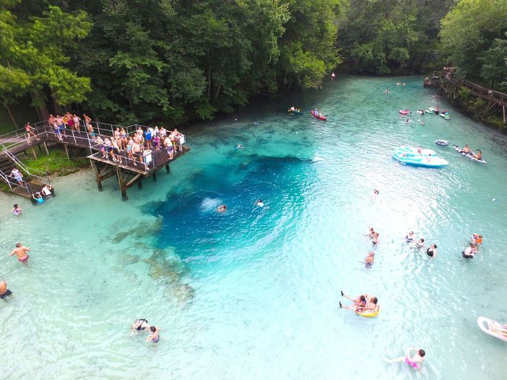 many people are swimming in the blue water