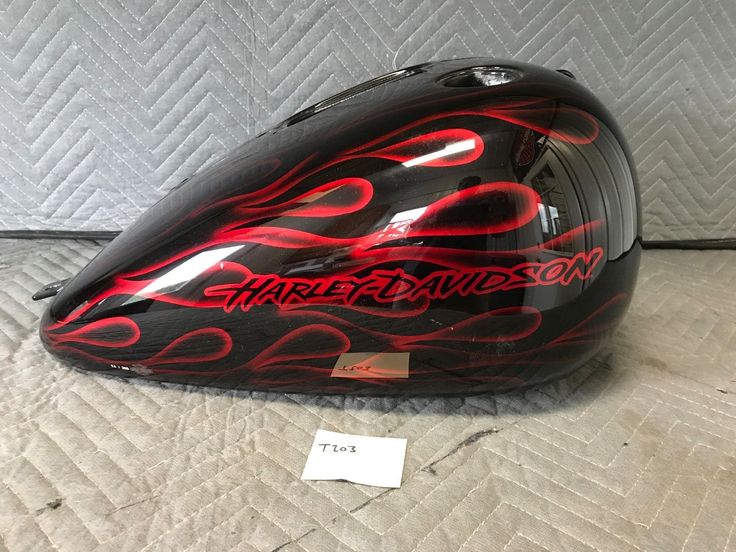 a motorcycle helmet sitting on top of a bed next to a price label for the helmet