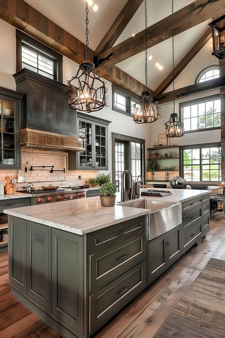 a large kitchen with an island and wooden floors