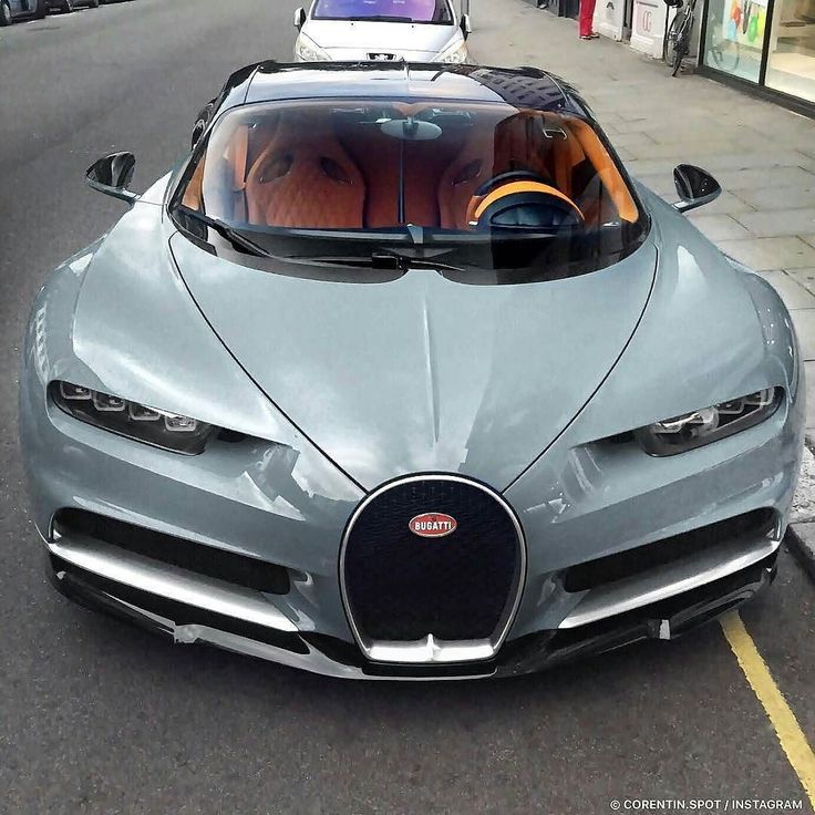 a bugatti is driving down the street in front of other cars