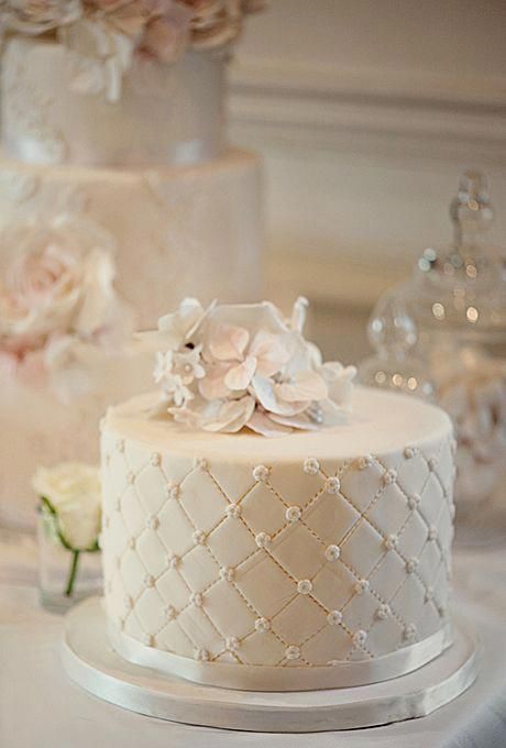 three tiered wedding cake with flowers on top