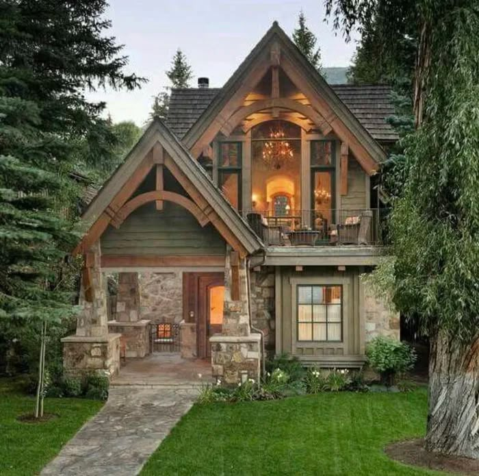 a large house with lots of windows in the front yard and trees on both sides