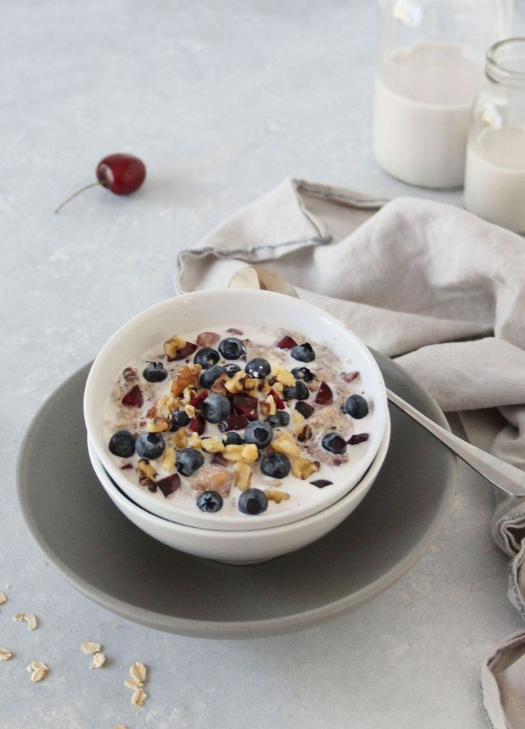 a bowl of oatmeal with blueberries and nuts