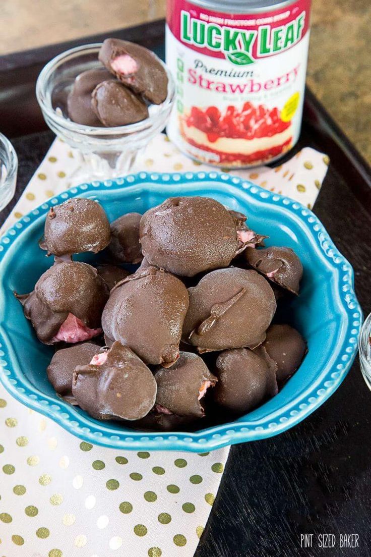 chocolate covered donuts in a blue bowl next to a can of lucky leaf ice cream