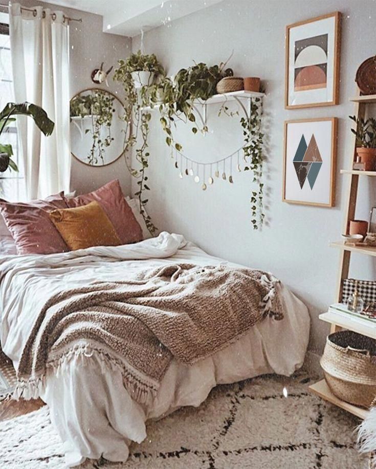 a bedroom with white walls and plants on the wall above the bed, along with hanging planters