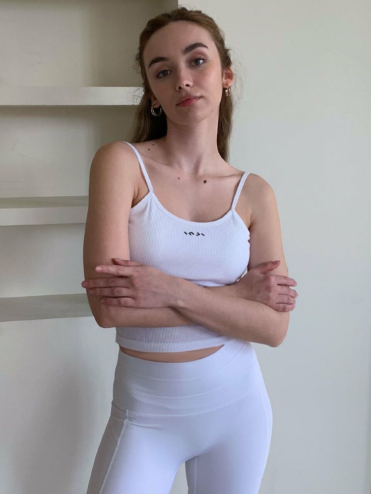 Editor's Notes The sleeveless top has bra pads built in. They can be removed if necessary. - Casual yet stylish fit- INJIACTIVE logo at the front chest- Simple, clean designMeasurements(in.)ONE SIZE- Chest: 14.17 in.- Bottom Hem: 12.01 in.- Length: 16.14 in. Composition & Care- 95% Cotton, 5% Spandex- Wash separately with alike colors in cold water- Do not bleach- Tumble dry at low setting- Do not iron or dry clean- After removing moisture dry at a shade- If it's a sports Fitted Cami Tops With Medium Bust Support, Fitted Sleeveless Tank Top With Adjustable Straps, Gym Tops With Medium Bust Support For Summer, Medium Support Camisole Tops For Workout, Sleeveless Tank Top With Adjustable Straps And Medium Support, Sleeveless Fitted Top With Adjustable Straps, Athleisure Sleeveless Tank Top With Adjustable Straps, Medium Support Workout Camisole Top, White Bra Friendly Crop Top For Yoga