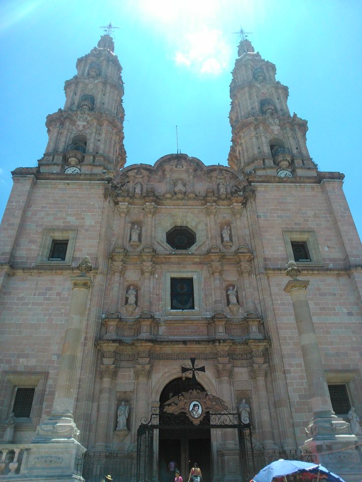 people standing in front of an old church