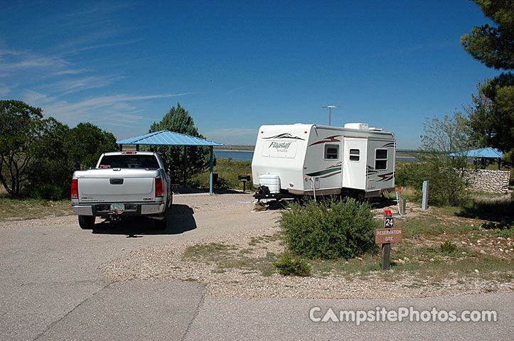 a white truck parked next to a camper trailer