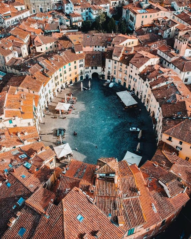 an aerial view of a city with lots of buildings and water in the middle of it