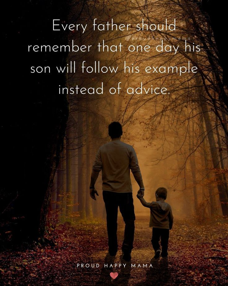 a father holding the hand of his son as he walks through an autumn forest