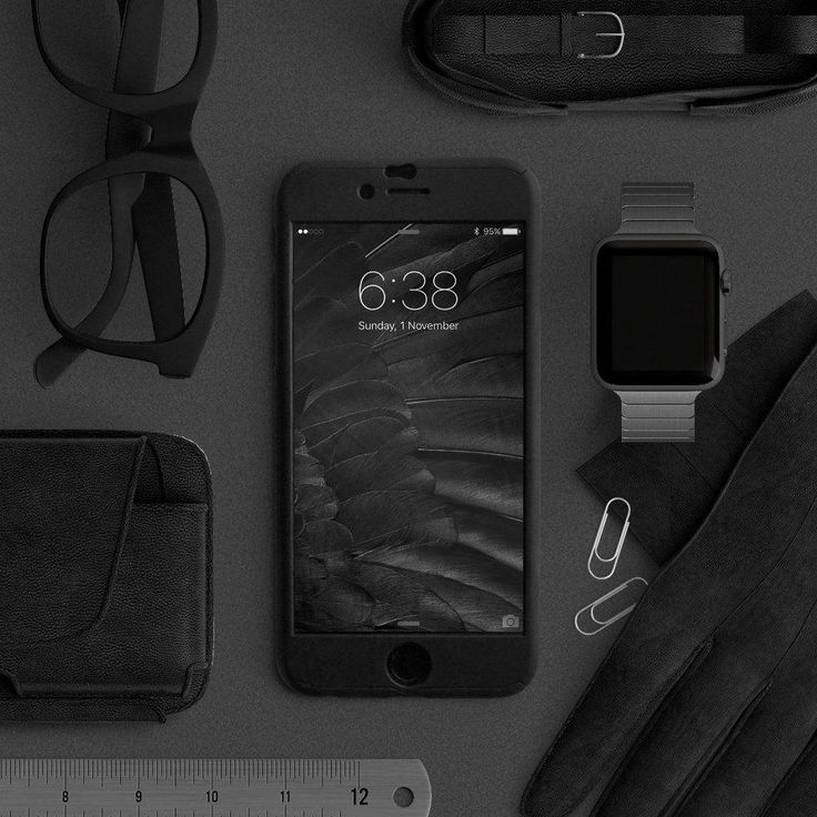 an iphone, watch, and other items are laid out on a gray surface next to a pair of glasses