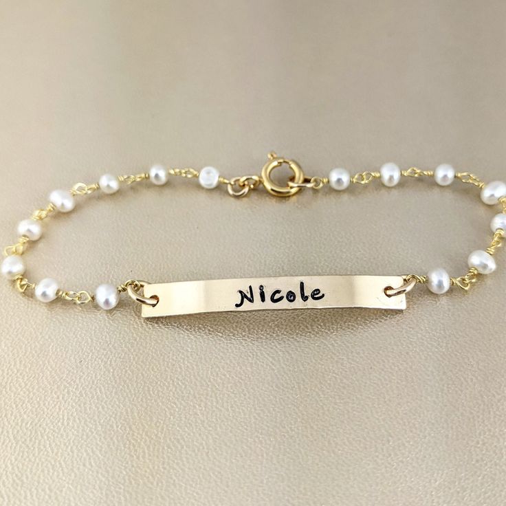 "Personalized Bracelet, Engraved Bar Bracelets, Stacking Bracelet, Bridesmaid Jewelry, Gold Name Bar Bracelet, Gift for Daughters Personalized with your very own delicate gemstone bracelet with a 14kt gold filled skinny bar disc. Perfect gift for yourself, Friend, Wife, Bridesmaids etc. Details for our Delicate Bracelet: ** Gemstones are wire wrapped with Gold Plated Over Sterling Silver Chain. Gemstone of your choice Stone 3-4mm ** 1 1/4\" x 1/8\" 14kt gold filled Rect disc with word, name, dat Bridesmaid Jewelry Gold, Engraved Bar Bracelet, Bracelet With Pearls, Initial Bracelet Gold, Schmuck Gold, Inspirational Bracelets, Bar Bracelet, Personalized Bracelet, Purple Pearl