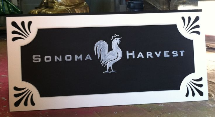 there is a sign that says sonoma harvest next to a gold statue on the floor