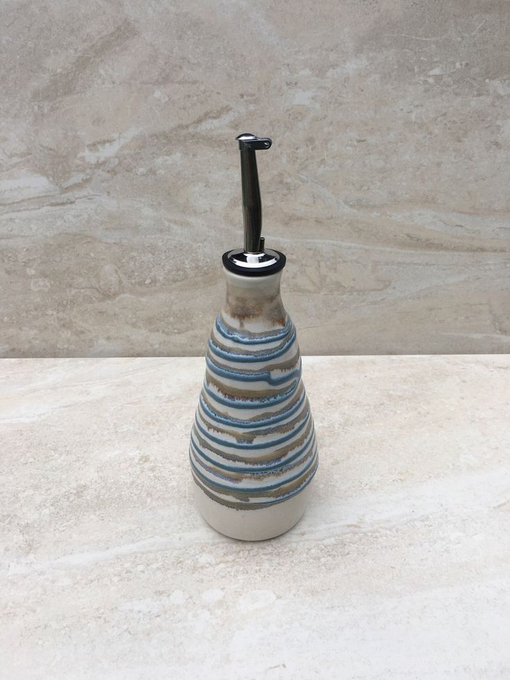 a blue and white vase sitting on top of a marble counter next to a wall