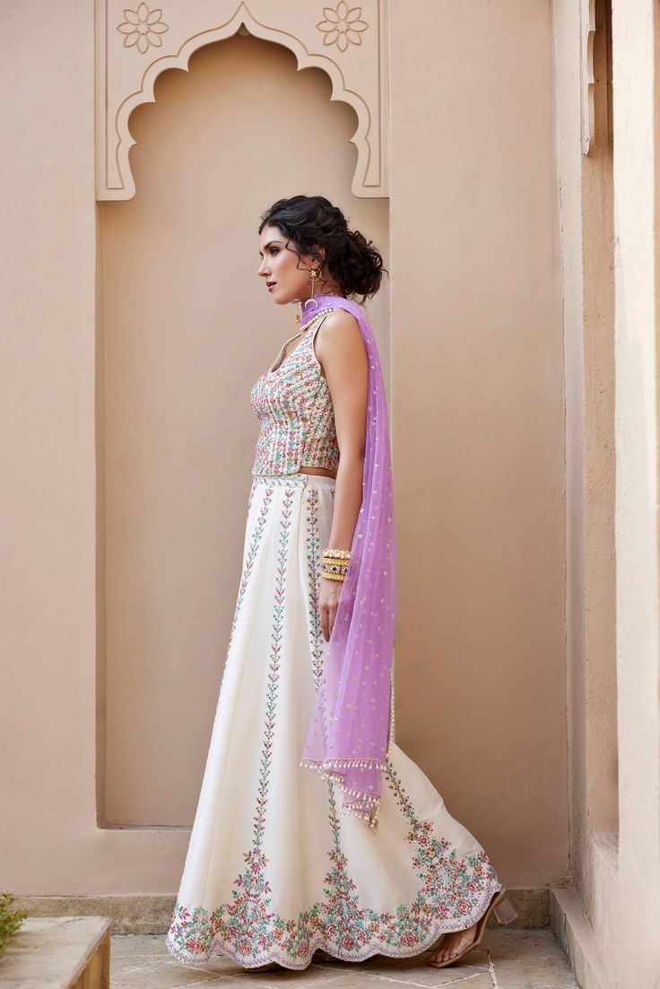 Mirror and Colorful resham Embroidered Ivory dupion silk top and flared pant Paired with contrast lavender Tulle dupatta with pearl embroidery detailing .From Chamee and Palak's The Romantics collection.DELIVERY TIMEPlease allow 8-12 weeks for your outfit to arrive.FABRIC DETAILSDupion SilkProfessional cleaning only. Pearl Embroidery, Embroidery Detailing, Dupion Silk, Change Image, 12 Weeks, Indo Western, Silk Top, Body Measurements, Skirt Length