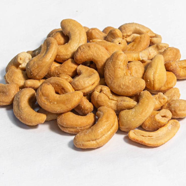 a pile of cashews sitting on top of a white table