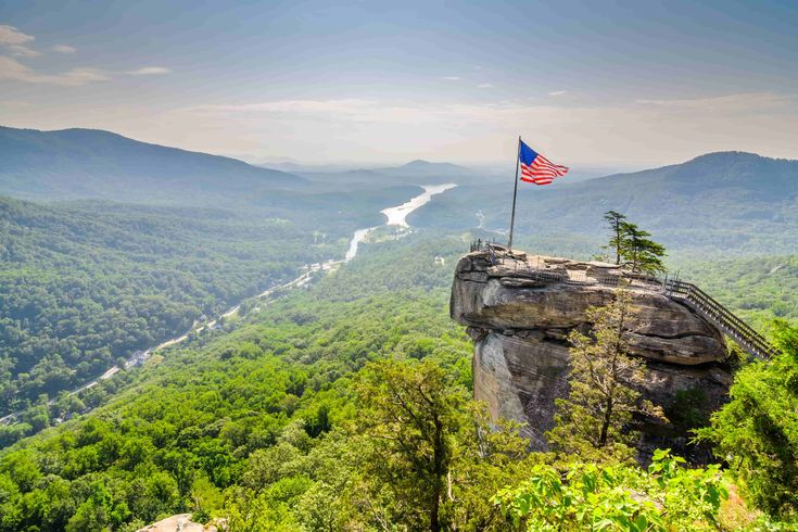 an american flag on top of a mountain