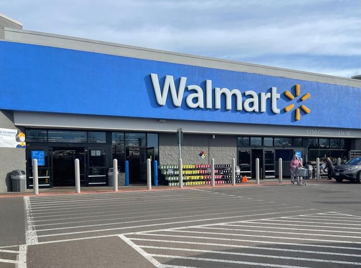 a walmart store with cars parked in the parking lot and people walking out front