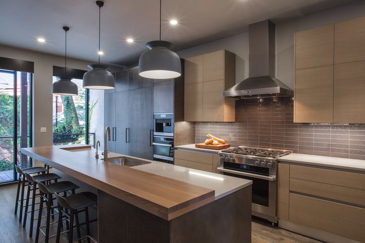 a modern kitchen with an island and stainless steel appliances