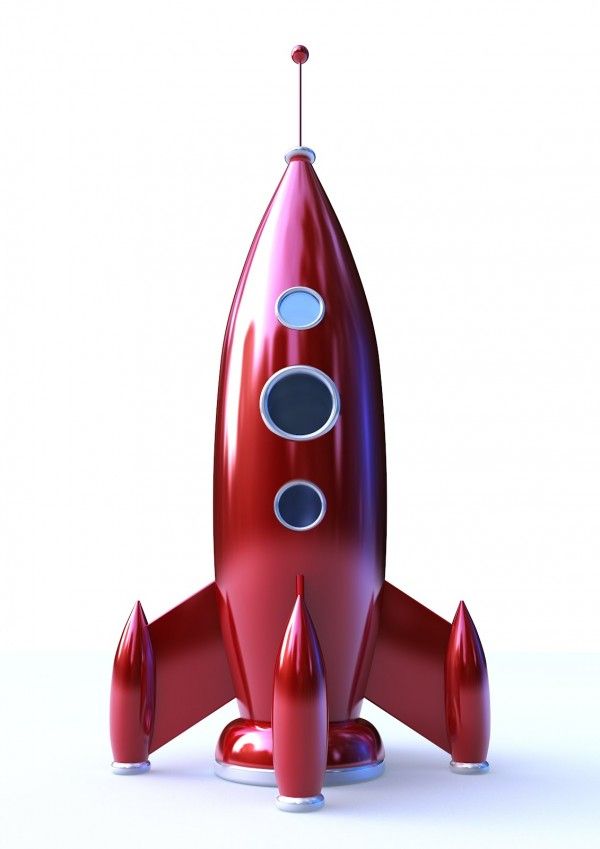 a red toy rocket ship sitting on top of a white surface