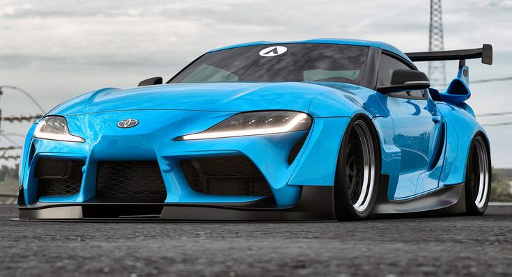 a blue toyota sports car parked on the street with power lines in the back ground